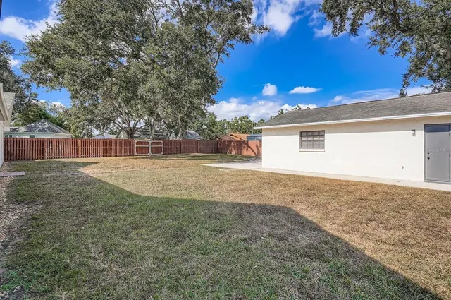 a view of a backyard with large trees