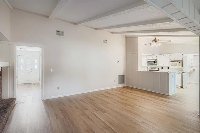 a view of a kitchen with wooden floor and a kitchen