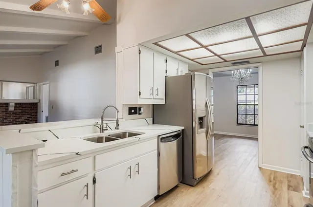 a kitchen with a sink appliances and cabinets