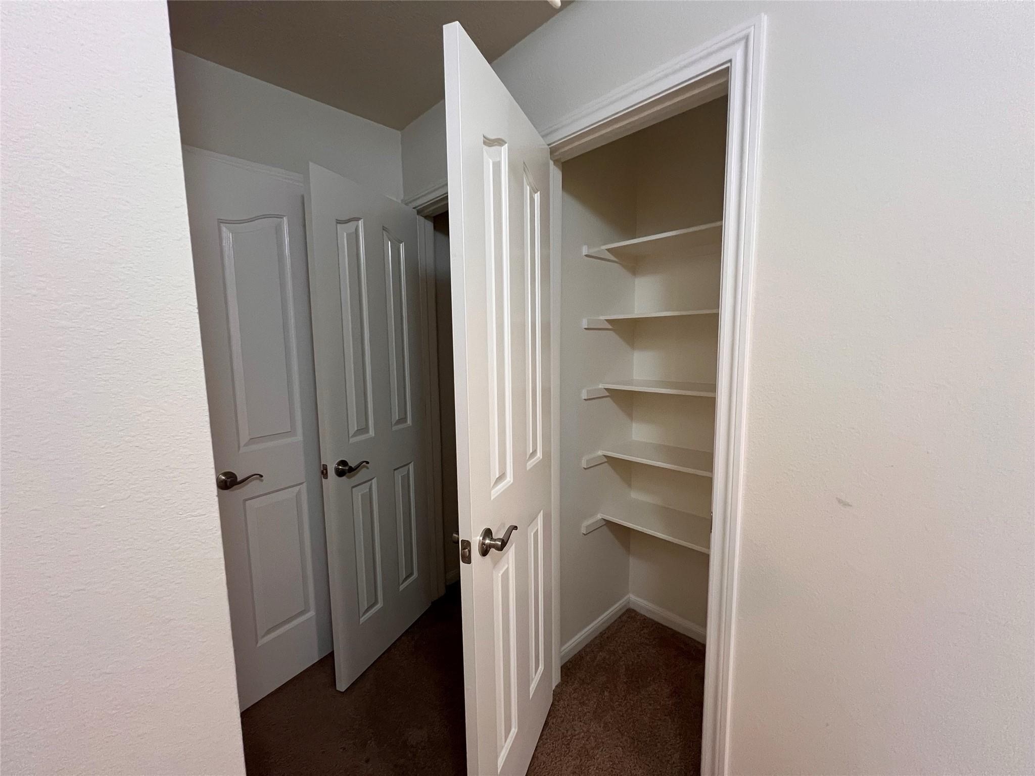 2502 Redrock Road League City, TX 77573 - Photo 12 of 19 Additional storage options are conveniently located along the private hallway, including a coat closet and a linen closet, ensuring ample space for all your essentials.