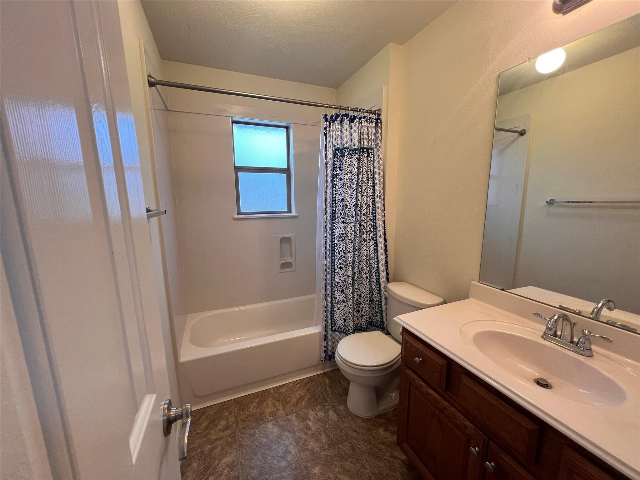 2502 Redrock Road League City, TX 77573 - Photo 15 of 19 The secondary bathroom features a tub shower combo, and the functional window adds a refreshing touch by allowing natural light and ventilation, making the space feel open and airy.