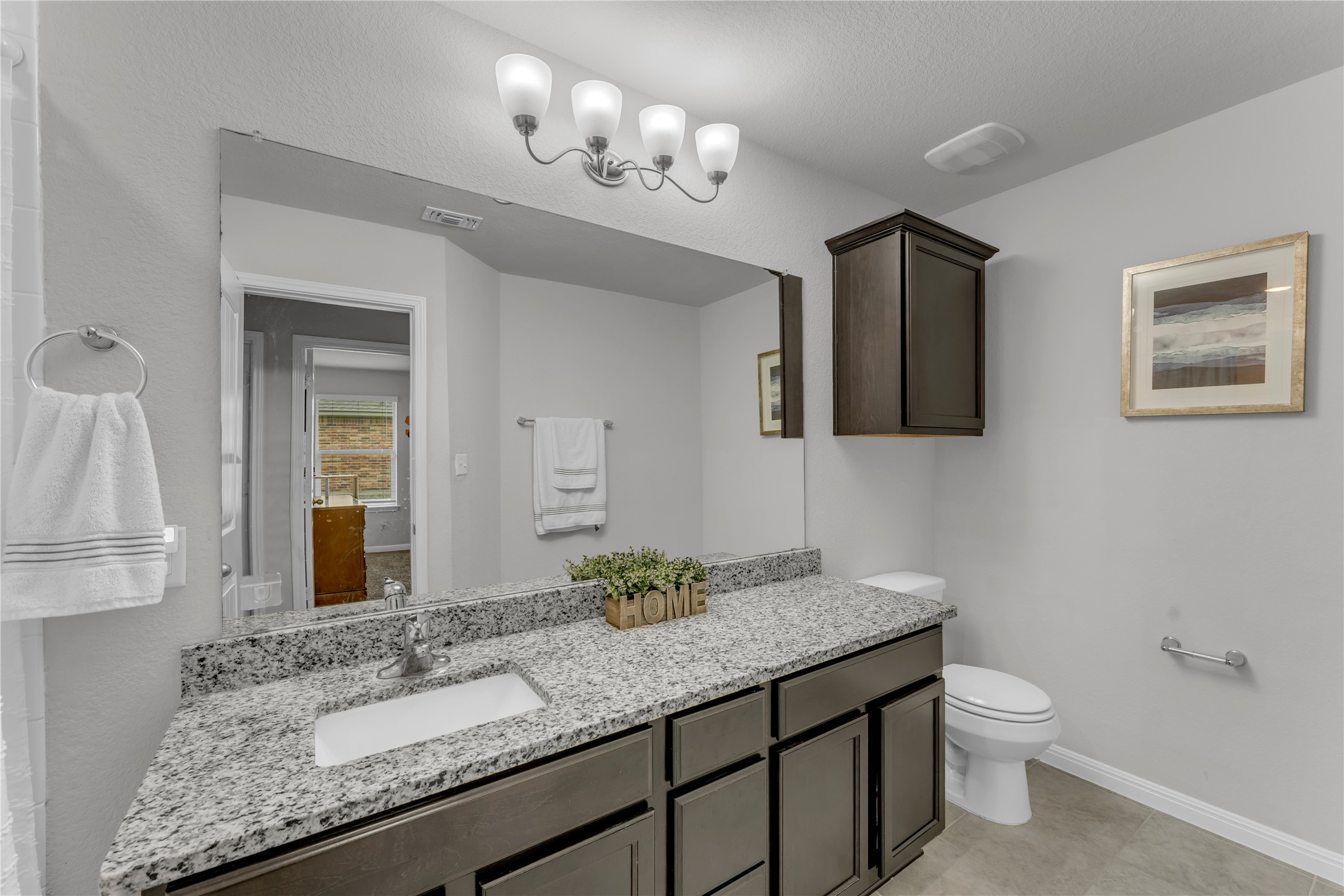 132 Cinnamon Loop Burnet, TX 78611 - Photo 21 of 27 Bathroom vanity featuring a granite countertop with an undermount sink and dark wood-finish cabinetry