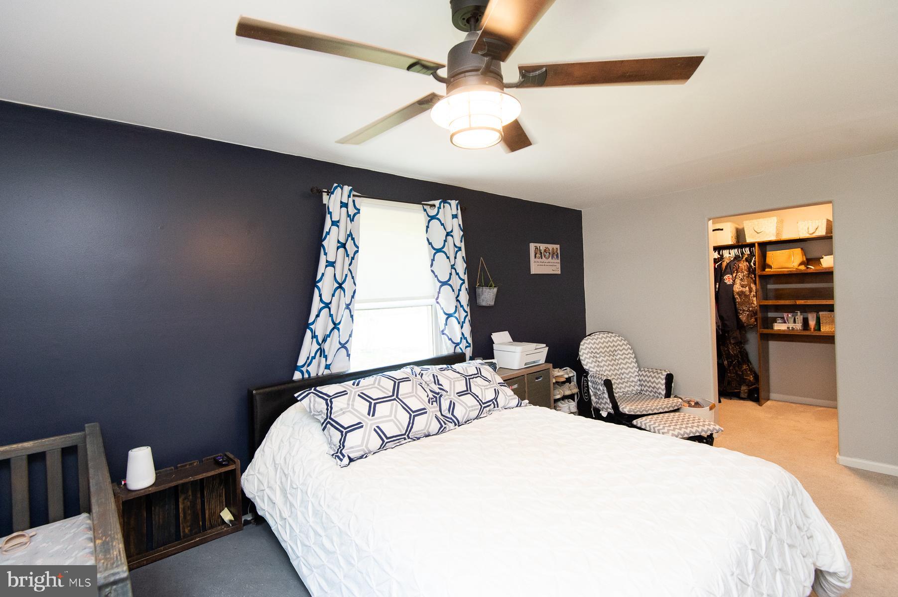 12 North Maple Avenue Ridgely, MD 21660 - Photo 19 of 30 a bedroom with a bed and a chandelier
