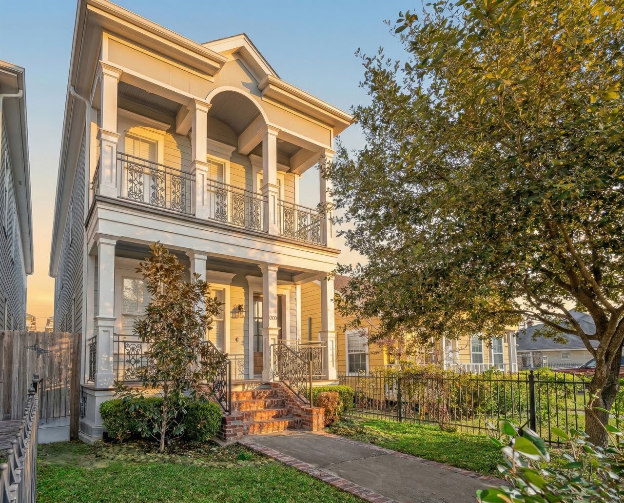 Welcome to 1003 E 25th Street! A charming New Orleans-style facade with double balconies and iron railings sets the tone in sought-after Sunset Heights.