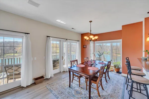 a bedroom with a bed and a dresser next to a window