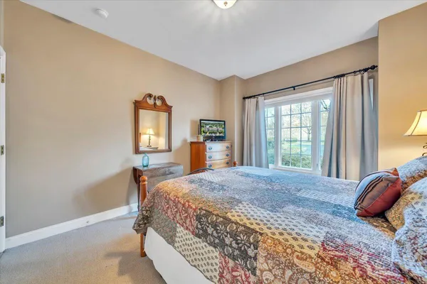 an aerial view of a house with a yard and lake view