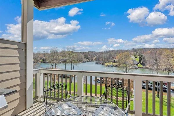an aerial view of residential houses with outdoor space and trees all around