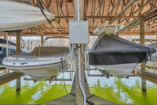 an aerial view of residential houses with outdoor space and lake view