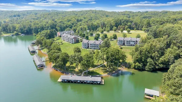 an aerial view of a house with a yard and lake view