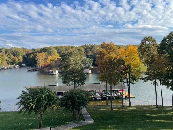 a view of a house with a yard and a large trees