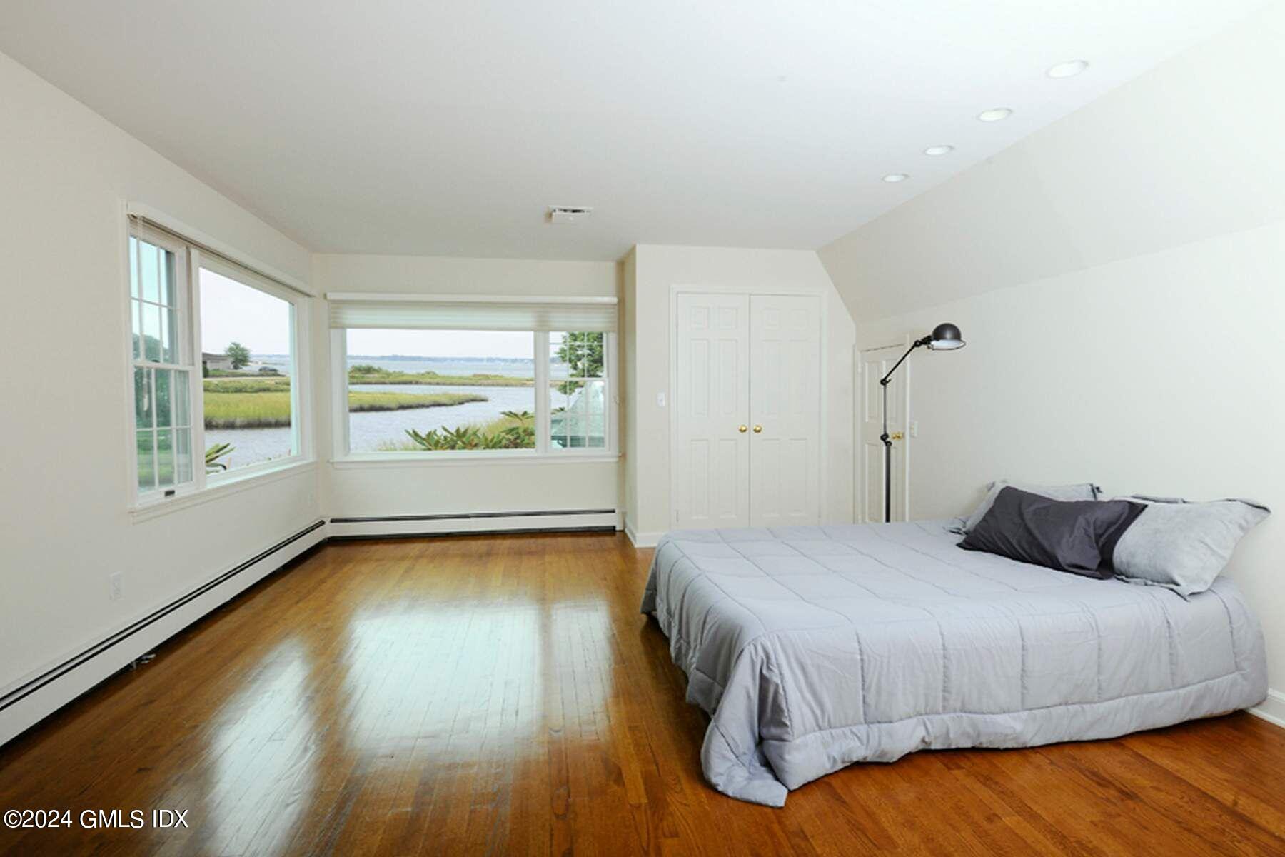 8 Indian Point Lane Riverside, CT 06878 - Photo 14 of 18 a bedroom with a bed and wooden floor