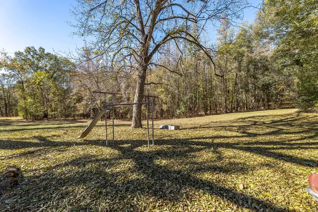 a view of a house with a yard porch and sitting area