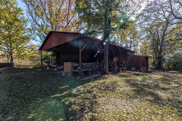 a view of a house with a yard and tree