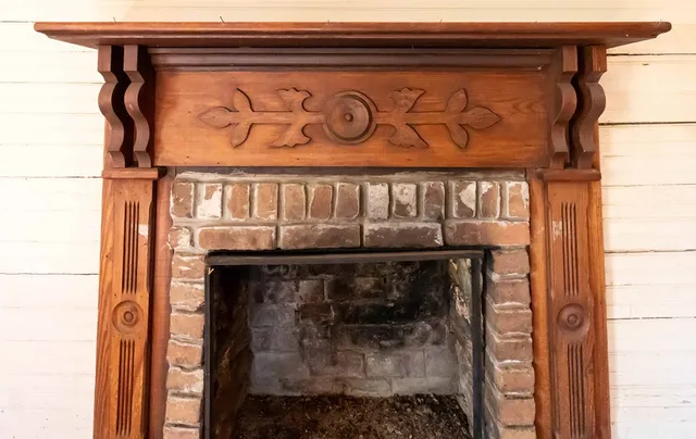 a close view of a fireplace with wooden frame