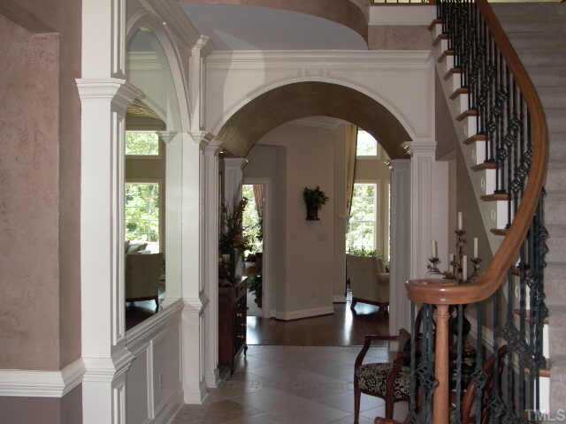 3915 Morvan Way Raleigh, NC 27612 - Photo 2 of 12 Elegant 2 story entry foyer with sweeping staircase of wrought iron spindles and wood hand rail. Handsome study and powder room is to the left. Also 2 coat closets in the foyer.