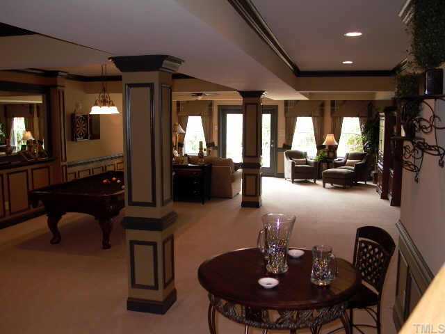 3915 Morvan Way Raleigh, NC 27612 - Photo 11 of 12 Finished lower level is huge and welcoming. Approx. 9 ft ceiling. Wet bar to the left has tile flooring, granite countertops & cherry cabinets. The double french door leads to mortared stone patio w/ outdoor fireplace & built in gas grill!