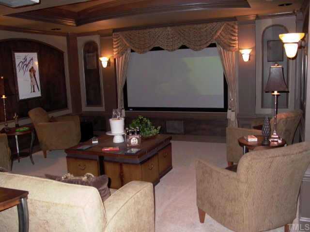 3915 Morvan Way Raleigh, NC 27612 - Photo 12 of 12 Media room is comfy and cozy. It boasts a dual trey ceiling, wall sconces, trim work and separate closet with built in to house media equipment and movie collection. Projector & movie screen conveys with this home.