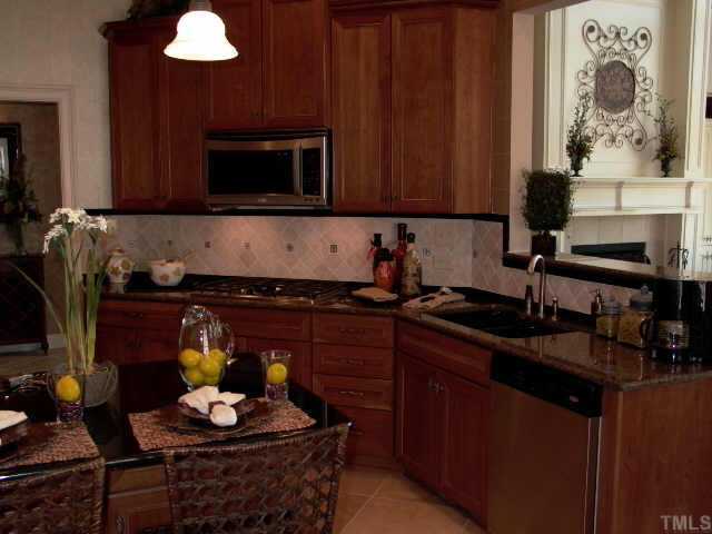 3915 Morvan Way Raleigh, NC 27612 - Photo 5 of 12 Great island and gas cooktop. There is a bar counter for guest to entertain you while you prepare your gourmet meal.