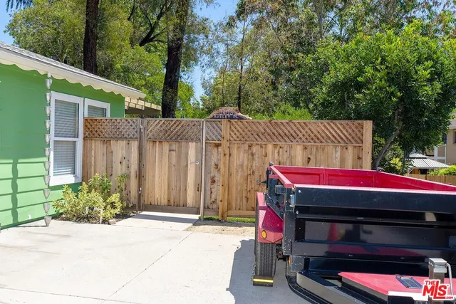 a view of a chairs and table in the backyard