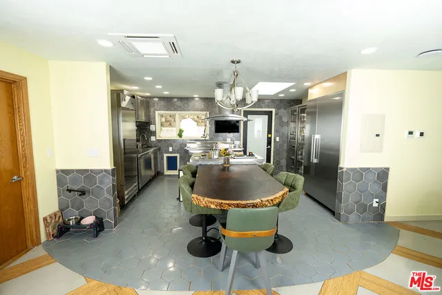 a dining room with furniture a table and kitchen view