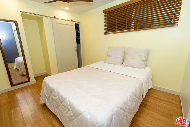 a large bed sitting in a bedroom next to a wooden door