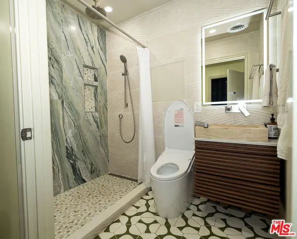 a bathroom with a sink toilet and shower