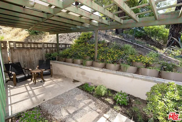 a view of a patio with table and chairs and potted plants