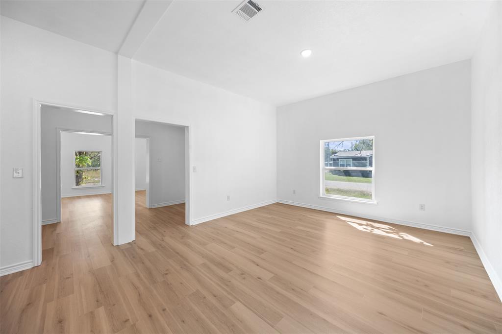 507 2nd Street Moody, TX 76557 - Photo 14 of 40 an empty room with wooden floor and windows