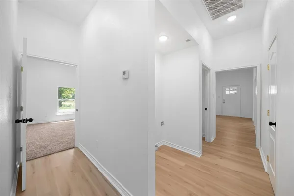 a view of hallway with wooden floor