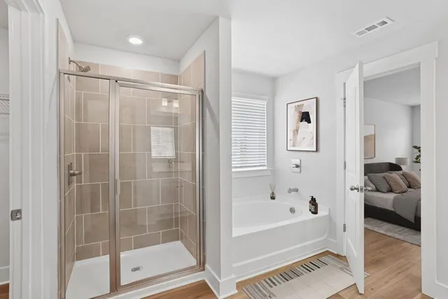 a bathroom with a bathtub and a shower