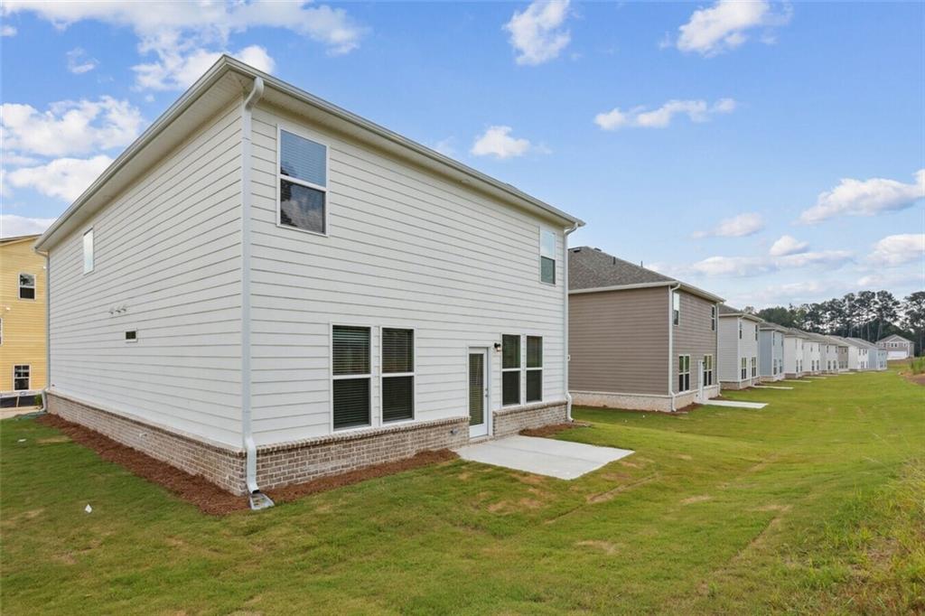 1575 Cedars Road Southeast, Unit REDBUD Lawrenceville, GA 30045 - Photo 16 of 17 a view of a house with a yard