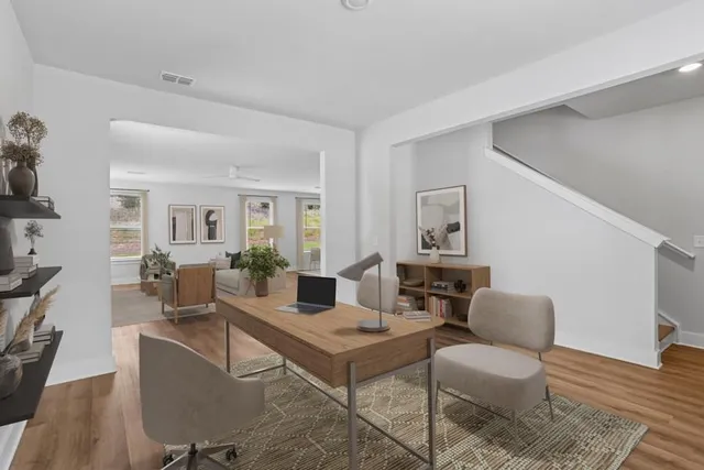a living room with furniture and wooden floor