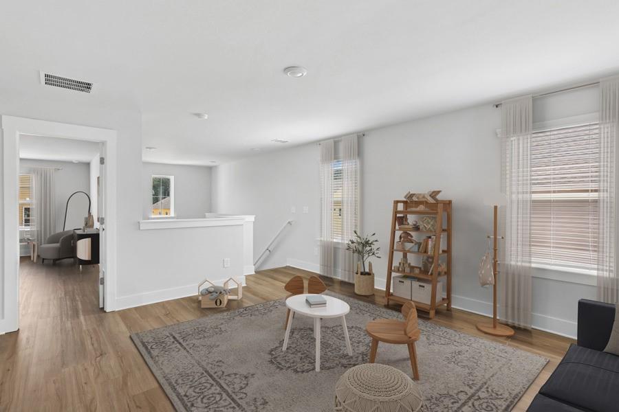 1575 Cedars Road Southeast, Unit REDBUD Lawrenceville, GA 30045 - Photo 5 of 17 a living room with furniture and a wooden floor