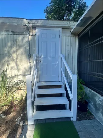 a view of entryway with wooden floor and a small yard