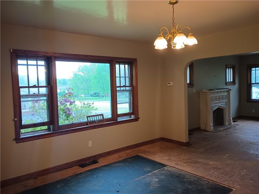 106 Conneaut Lake Road Greenville, PA 16125 - Photo 6 of 18 a view of a livingroom with a fireplace window and wooden floor