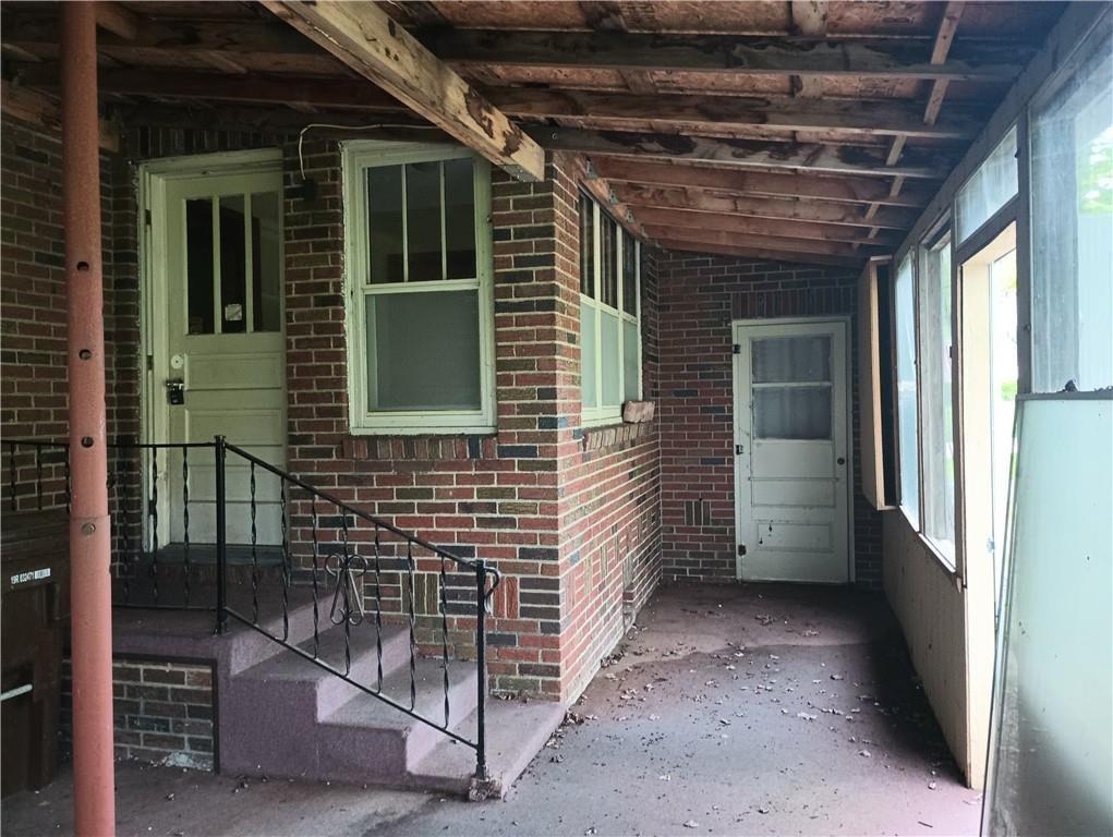 106 Conneaut Lake Road Greenville, PA 16125 - Photo 8 of 18 a view of a porch with a door and wooden floor