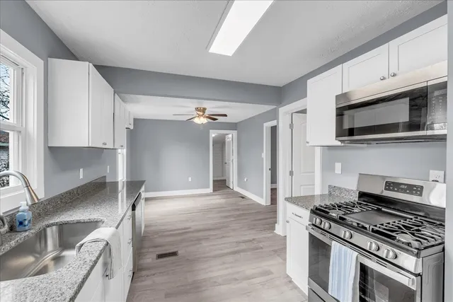 a kitchen with a refrigerator and a stove top oven