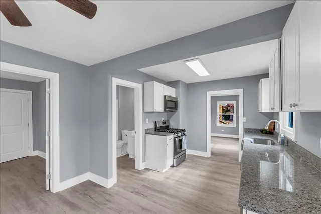 an empty room with a window and a fan