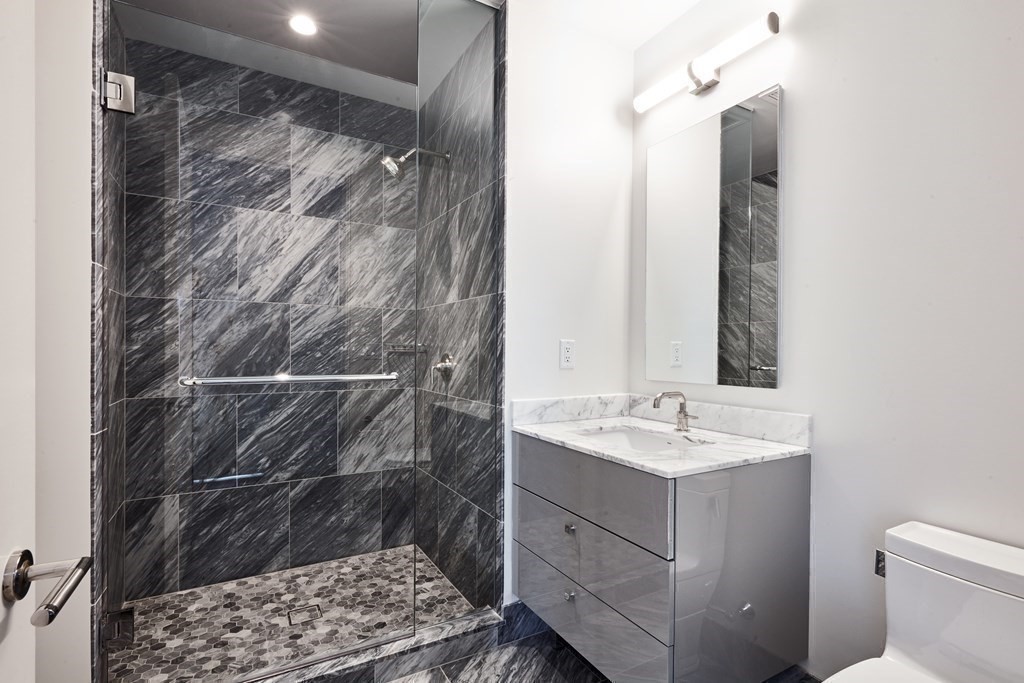 240 Devonshire Street, Unit 4708 Boston, MA 02110 - Photo 11 of 42 a bathroom with a sink and a mirror