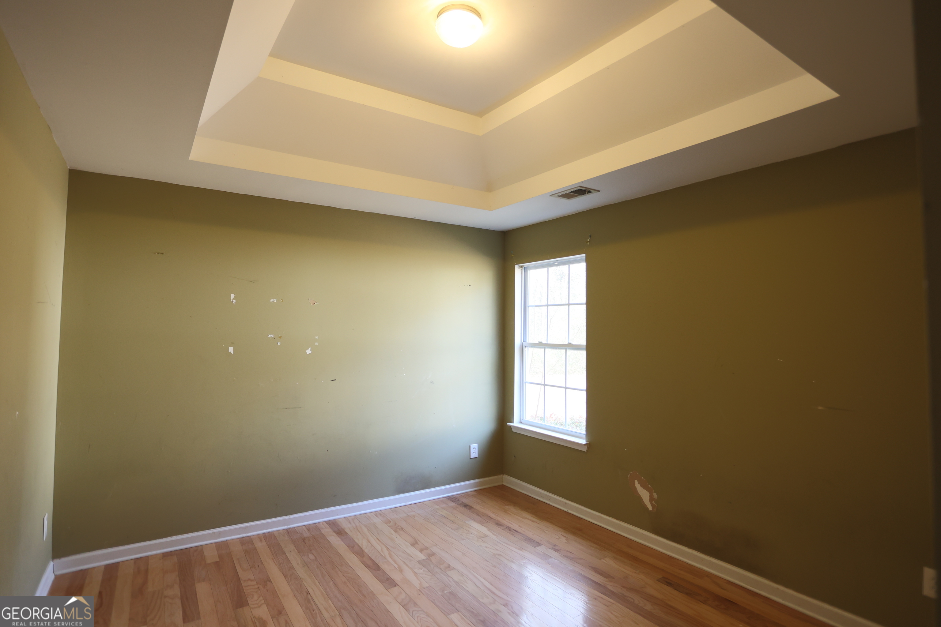 61 Concord Street North Concord, GA 30206 - Photo 14 of 37 an empty room with wooden floor and windows