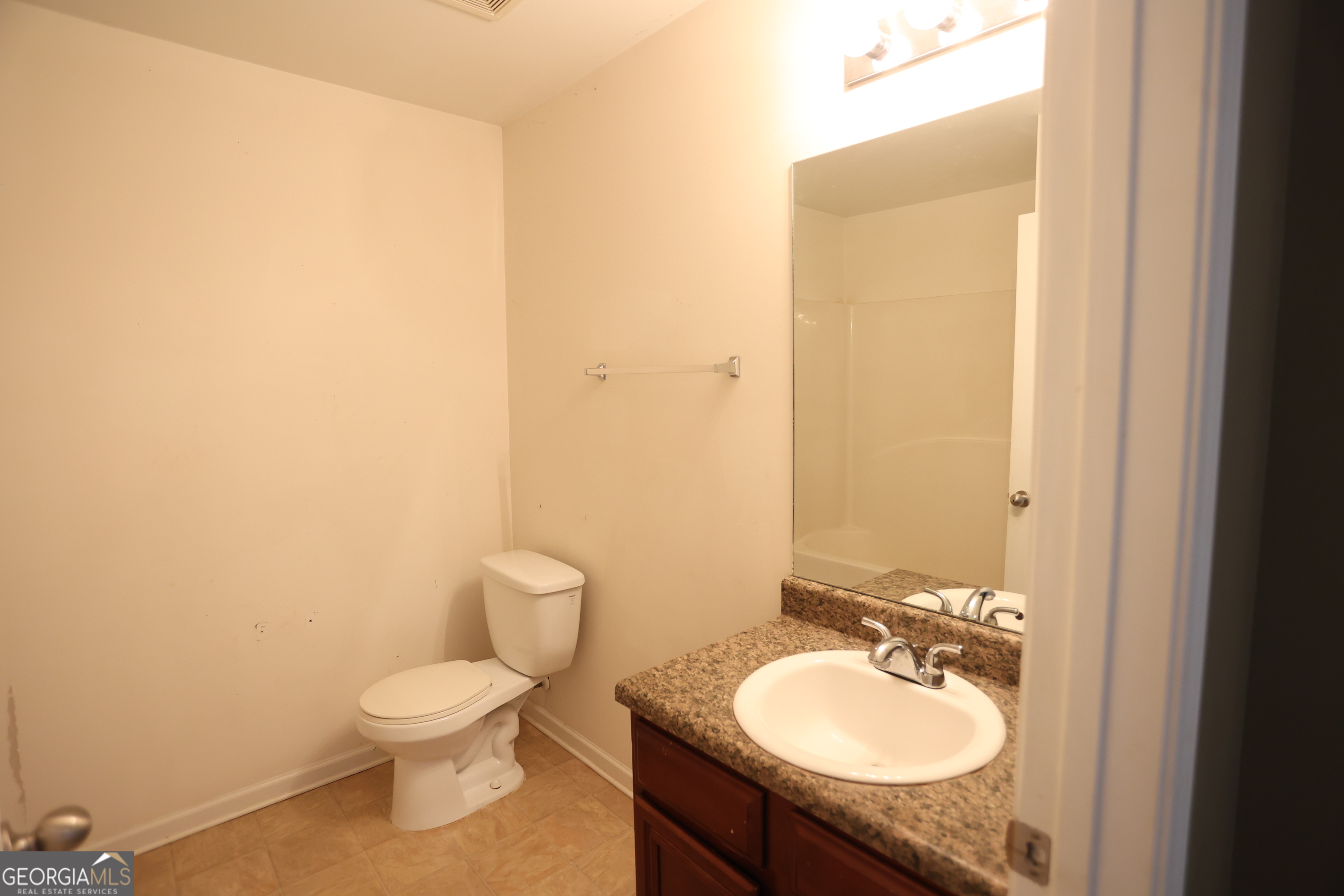 61 Concord Street North Concord, GA 30206 - Photo 15 of 37 a bathroom with a toilet sink and mirror