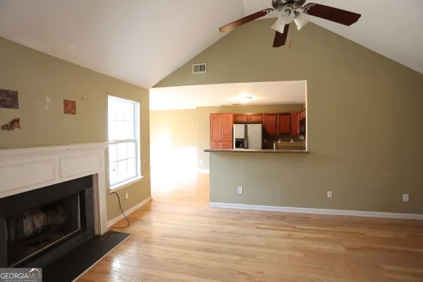 a view of a livingroom with a fireplace and cabinet
