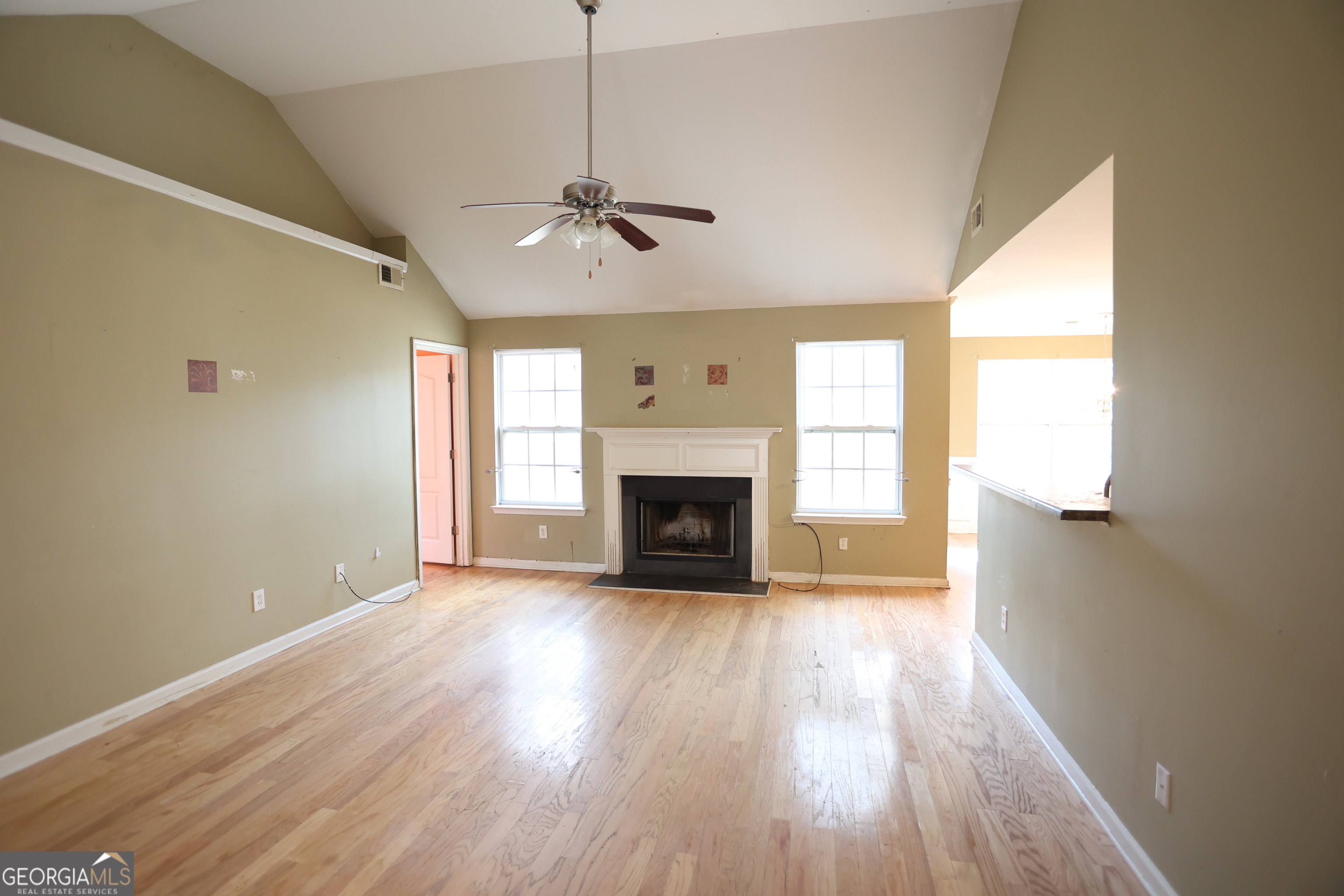 61 Concord Street North Concord, GA 30206 - Photo 17 of 37 a view of an empty room with wooden floor fireplace and a window