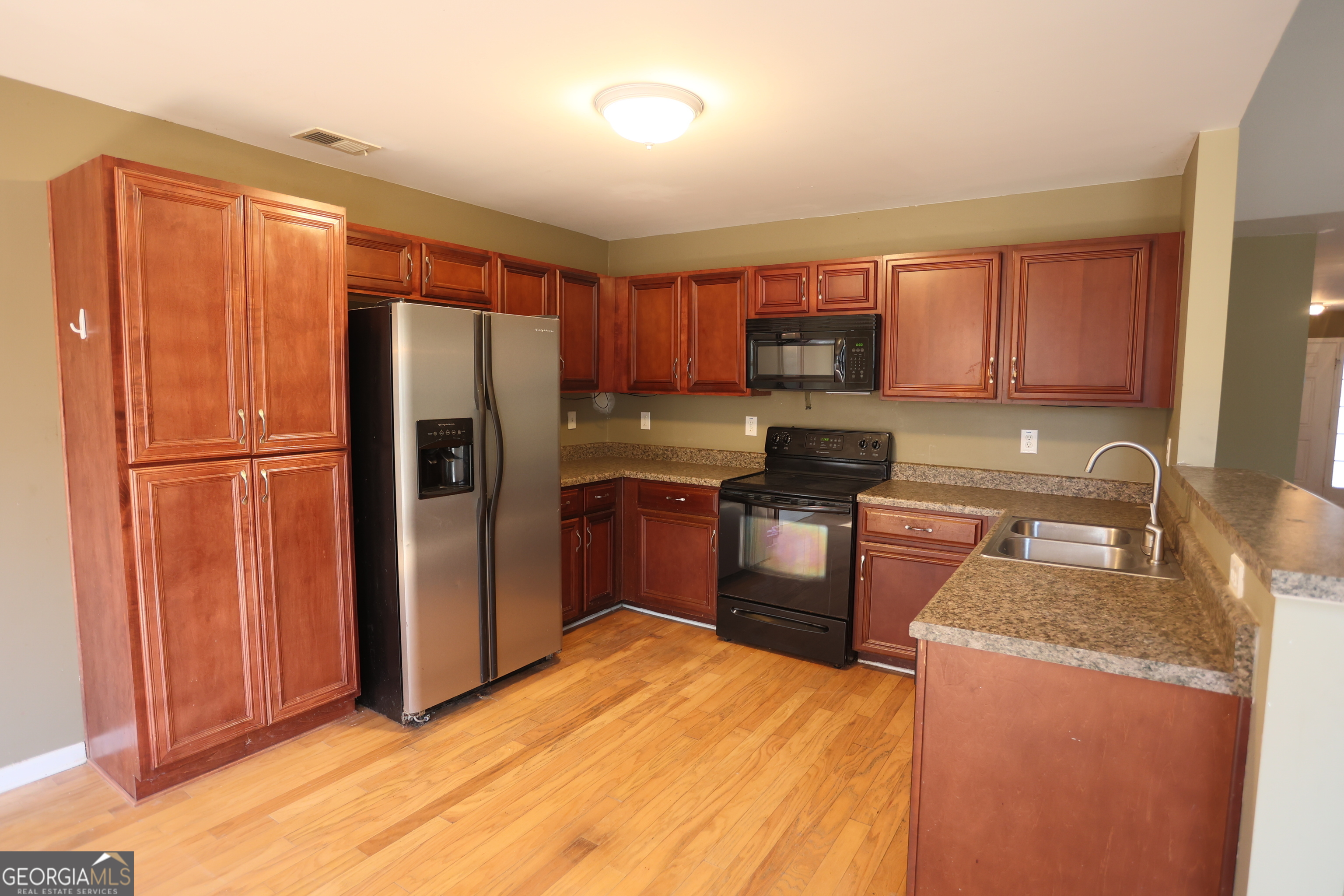 61 Concord Street North Concord, GA 30206 - Photo 22 of 37 a kitchen with granite countertop stainless steel appliances a refrigerator and a sink