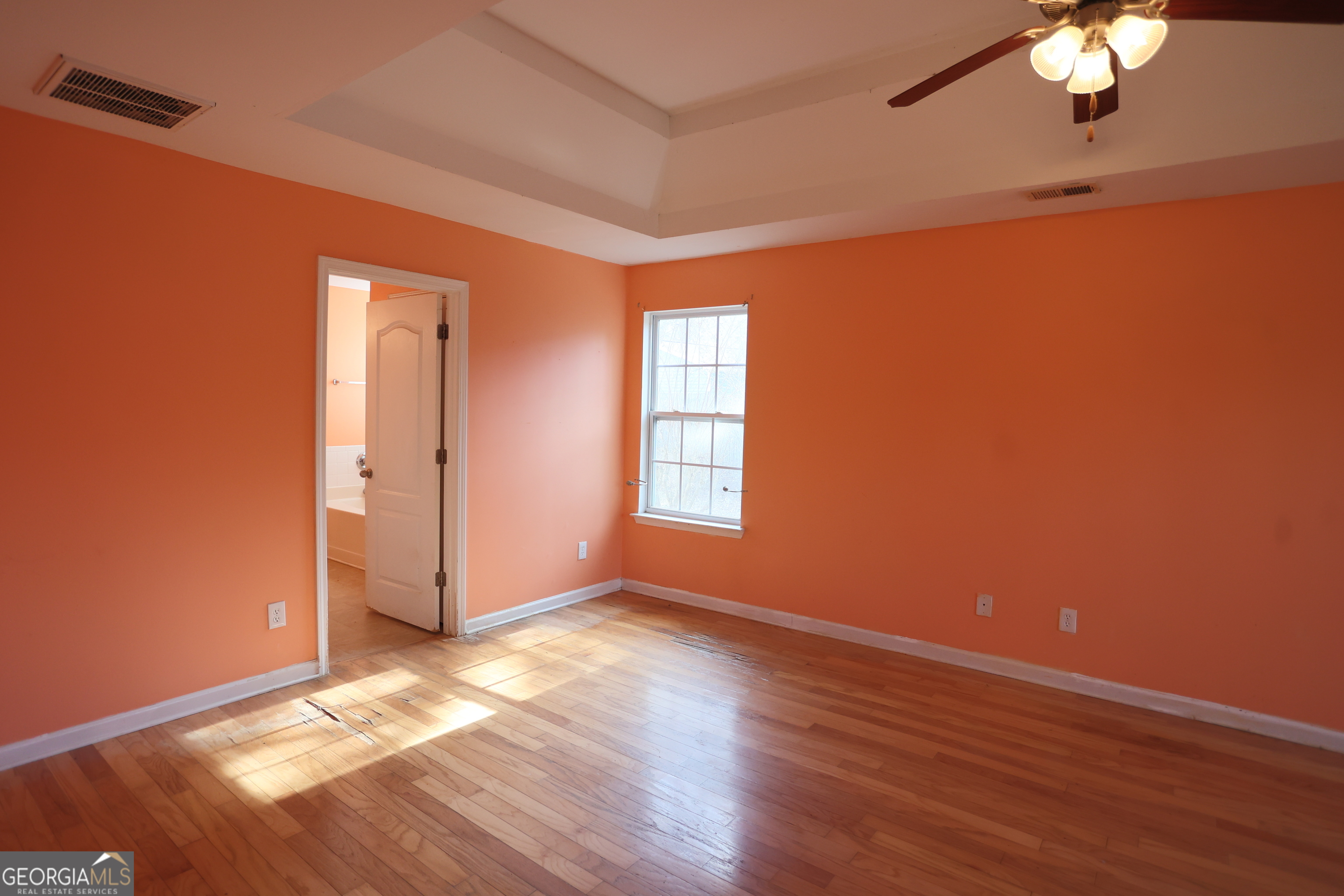 61 Concord Street North Concord, GA 30206 - Photo 26 of 37 an empty room with wooden floor chandelier fan and windows