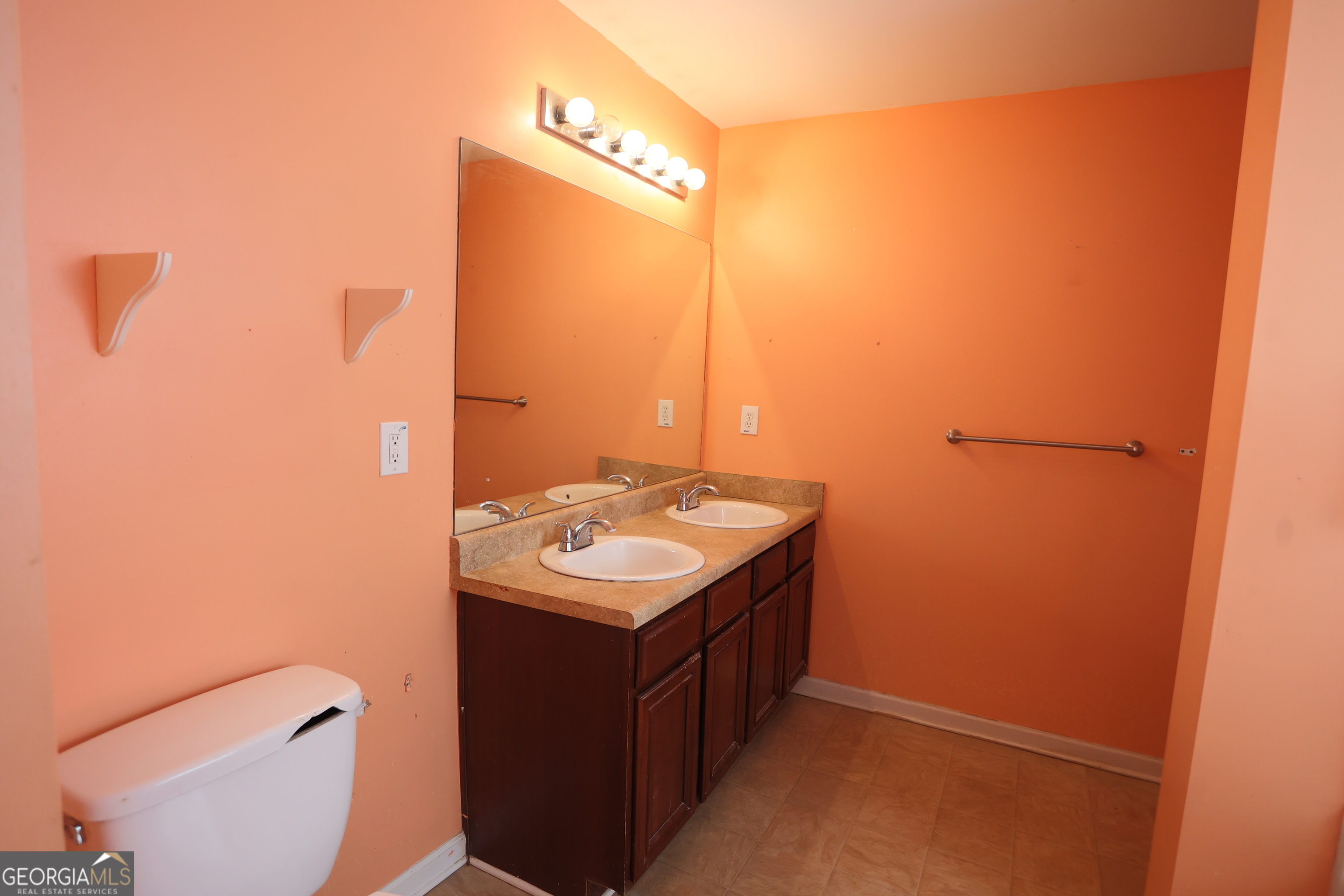 61 Concord Street North Concord, GA 30206 - Photo 29 of 37 a bathroom with a sink a toilet and mirror