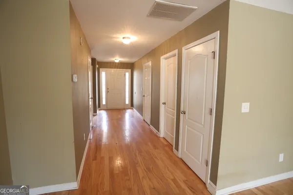 a view of a hallway with wooden floor