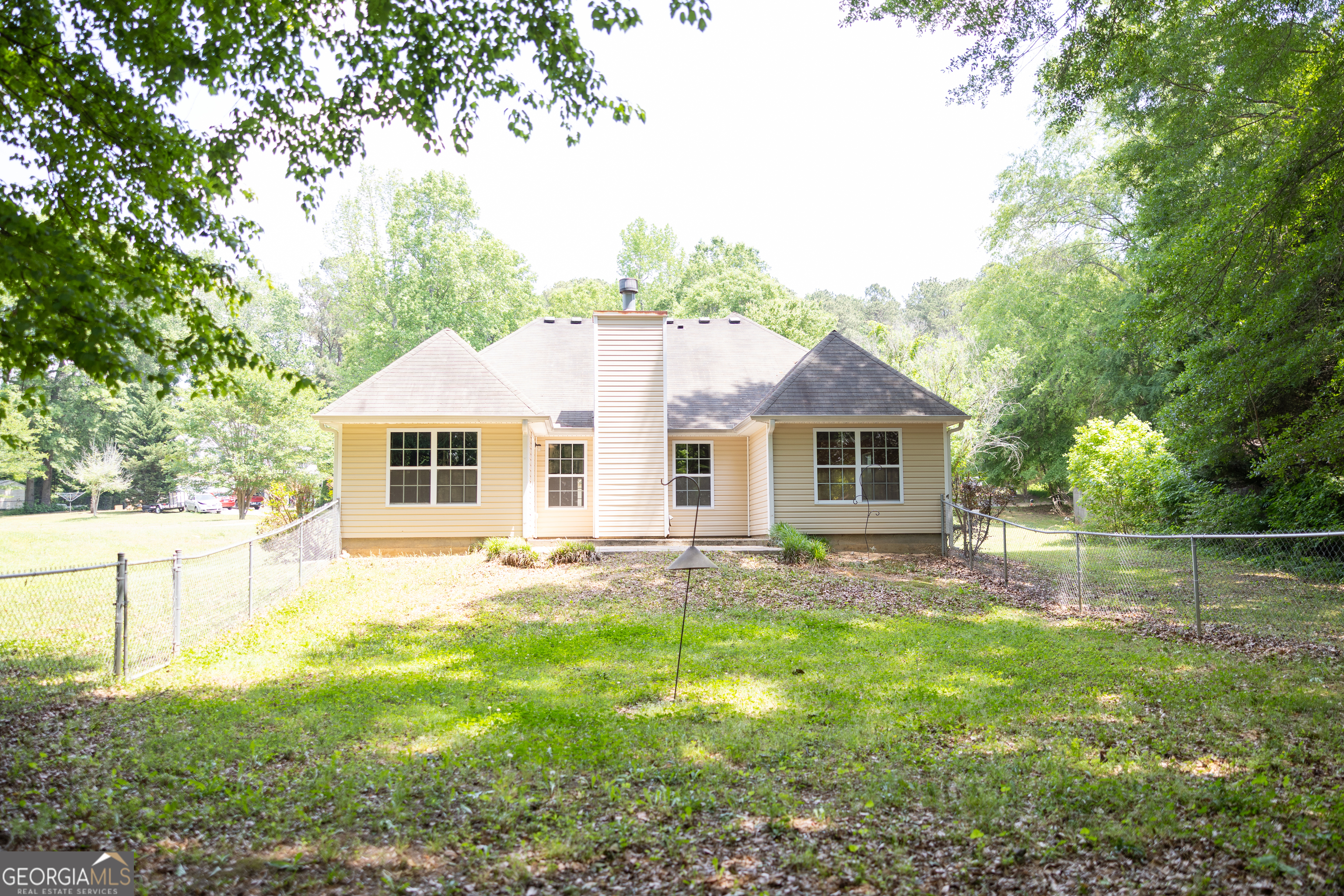 61 Concord Street North Concord, GA 30206 - Photo 6 of 37 a view of a yard in front of a house with large trees
