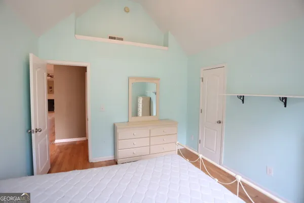 a bedroom with a bed and a dresser