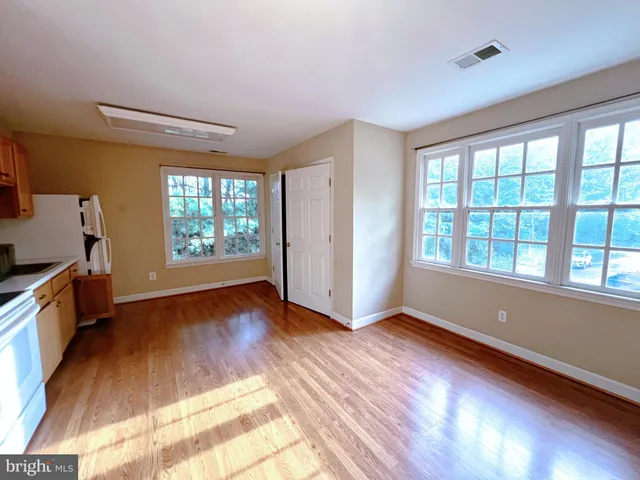 a kitchen with a refrigerator a sink and wooden cabinets